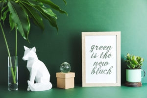 white cat statue on green wall, sign Green is the new black